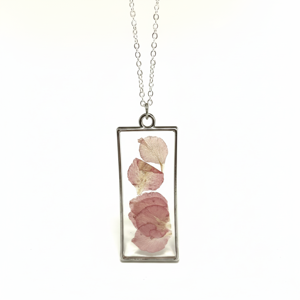 Rectangular pendant with pink petals suspended in resin