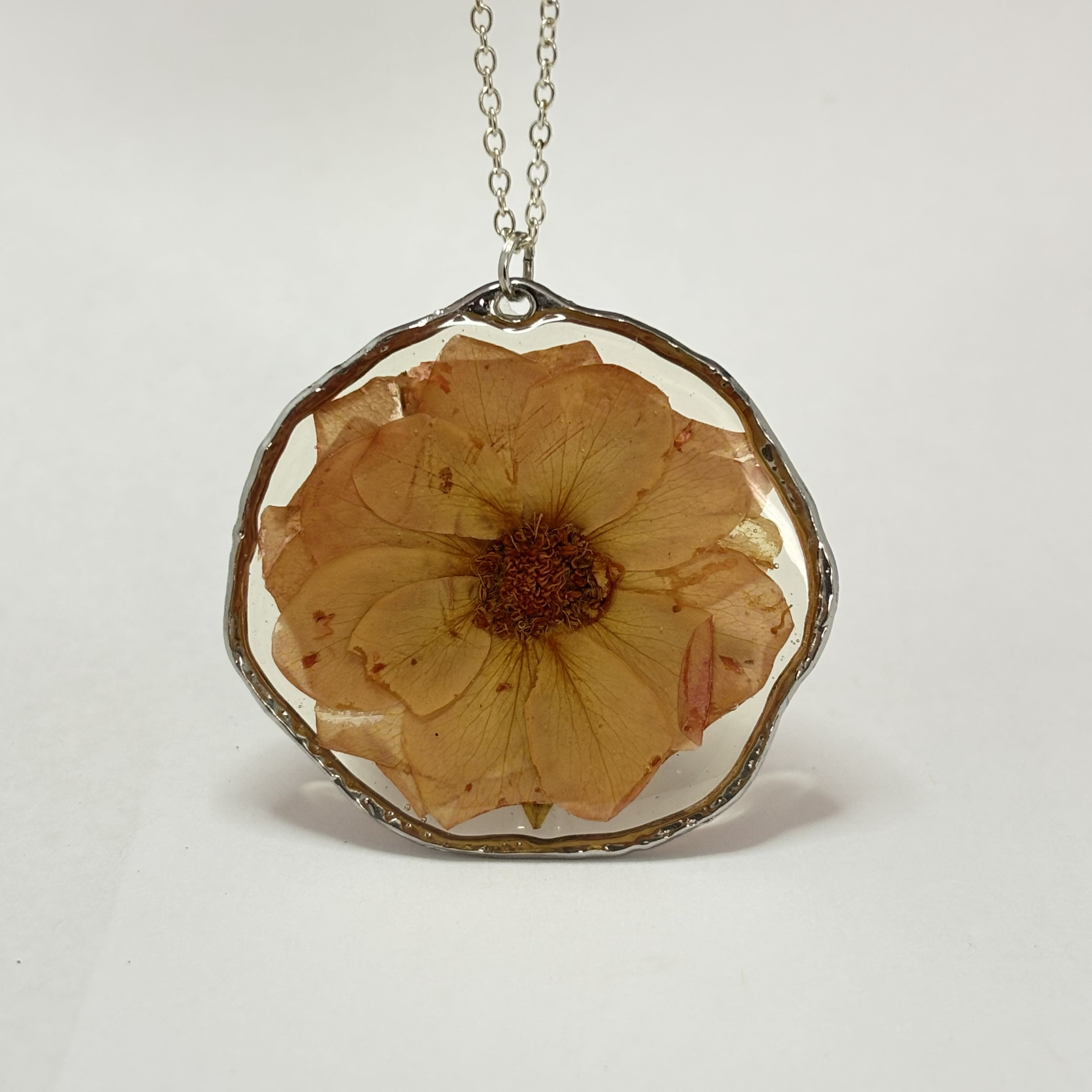 Close up of pressed rose pendant