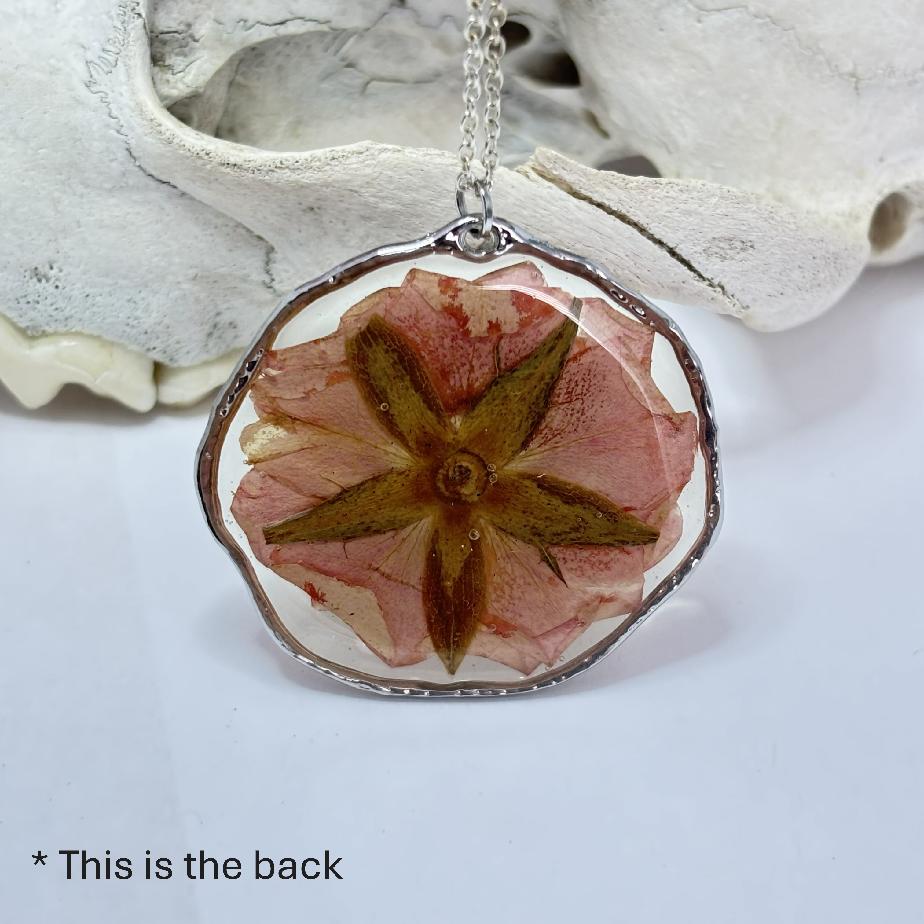 Back view of pressed rose pendant